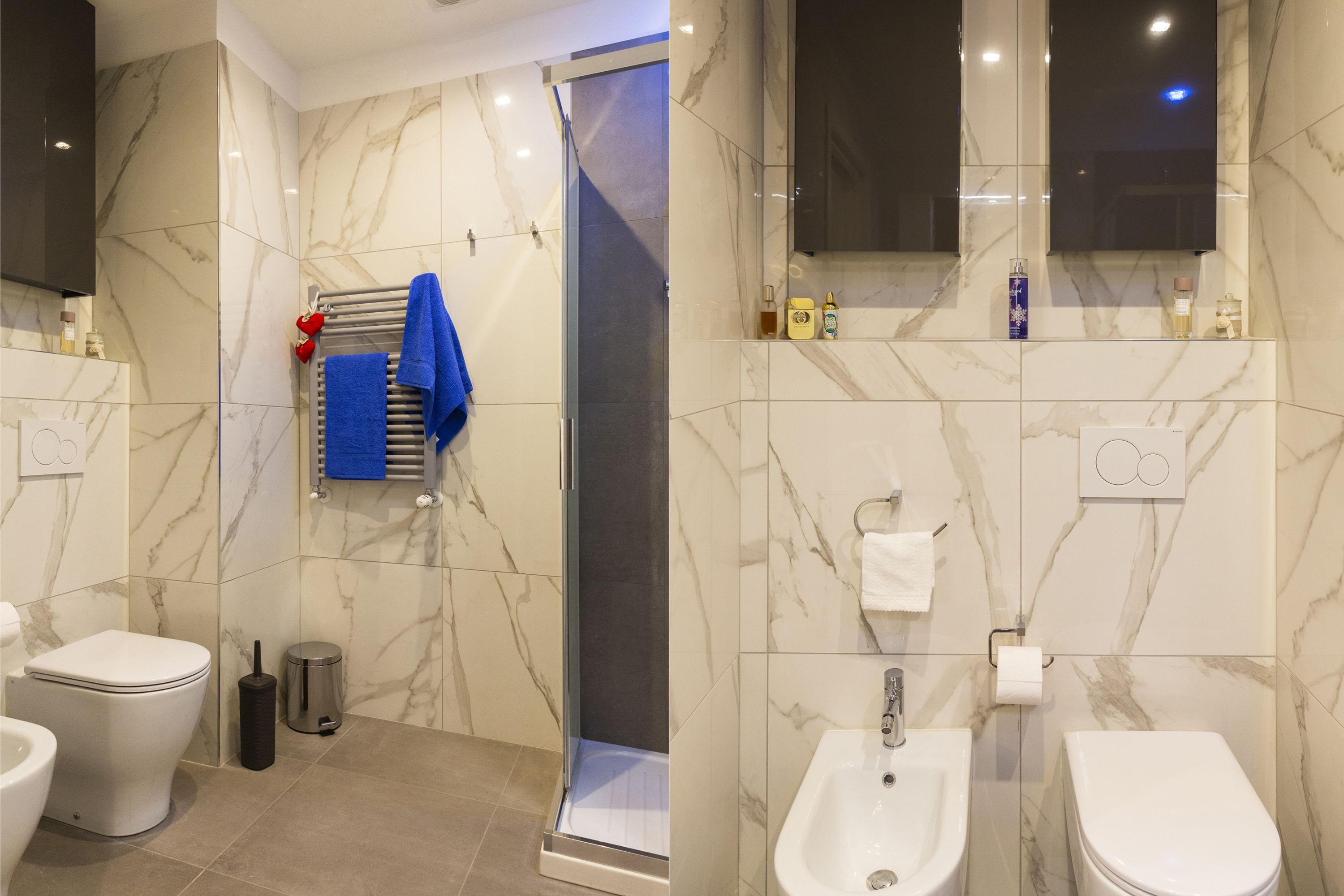 A modern bathroom with a toilet, bidet, and shower.