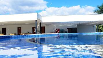 Guests can enjoy a refreshing swim in the hotel's large pool, surrounded by comfortable rooms and facilities.