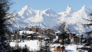 A snow-covered mountain resort with multiple chalet-style buildings, likely offering lodging and possibly ski facilities. - Pracondu 1 101 - OUTDOOR & FUN  apartment 8 pers (Haute-Nendaz)