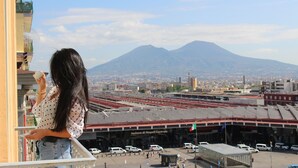 A view of a train station with a mountain in the background. - Philip Royal (Naples)