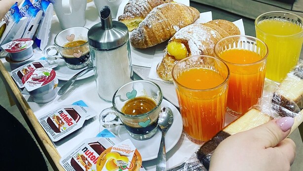 A breakfast table with pastries, coffee, and juice. - Philip Royal (Naples)