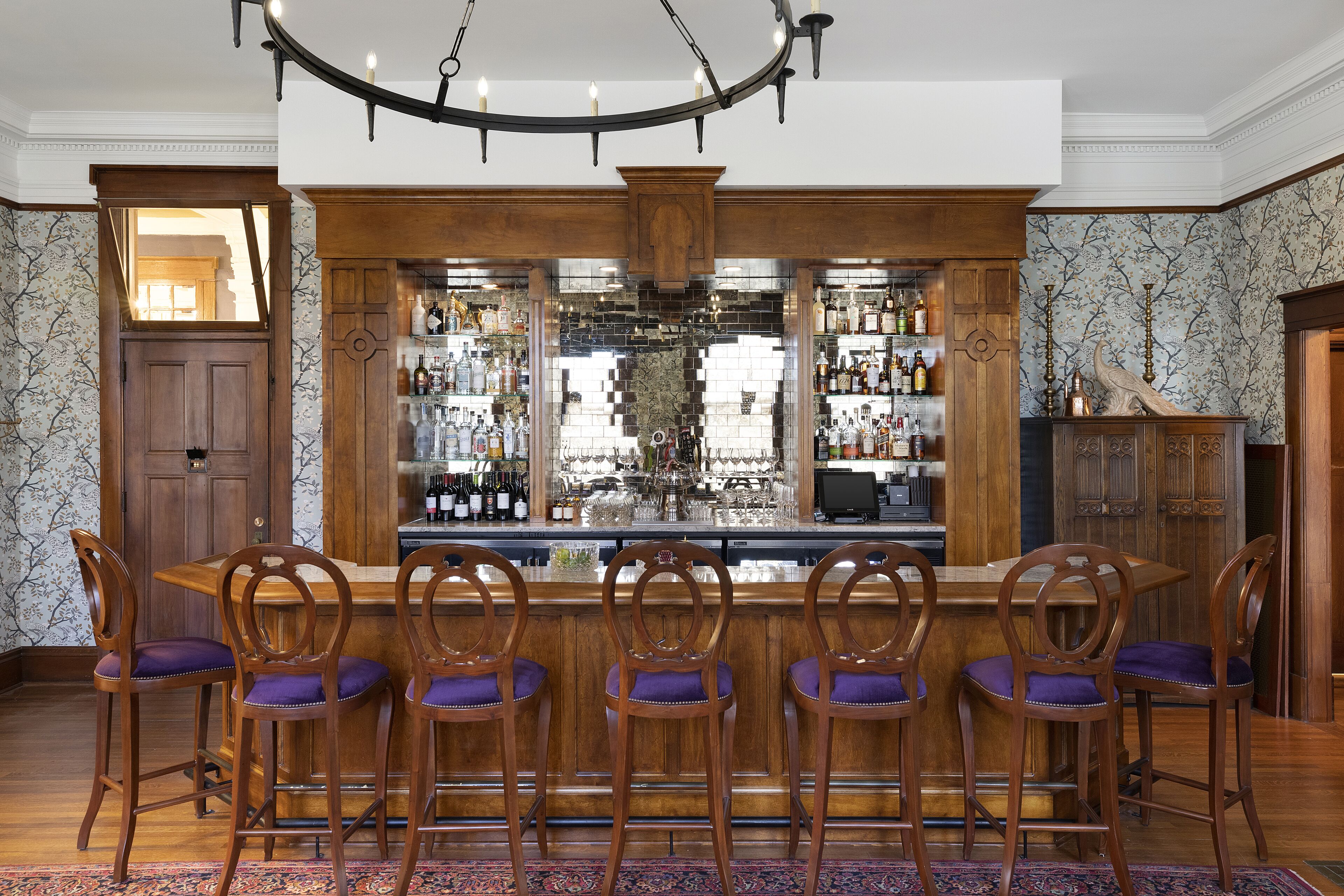 A bar area with wooden chairs and a bar counter.