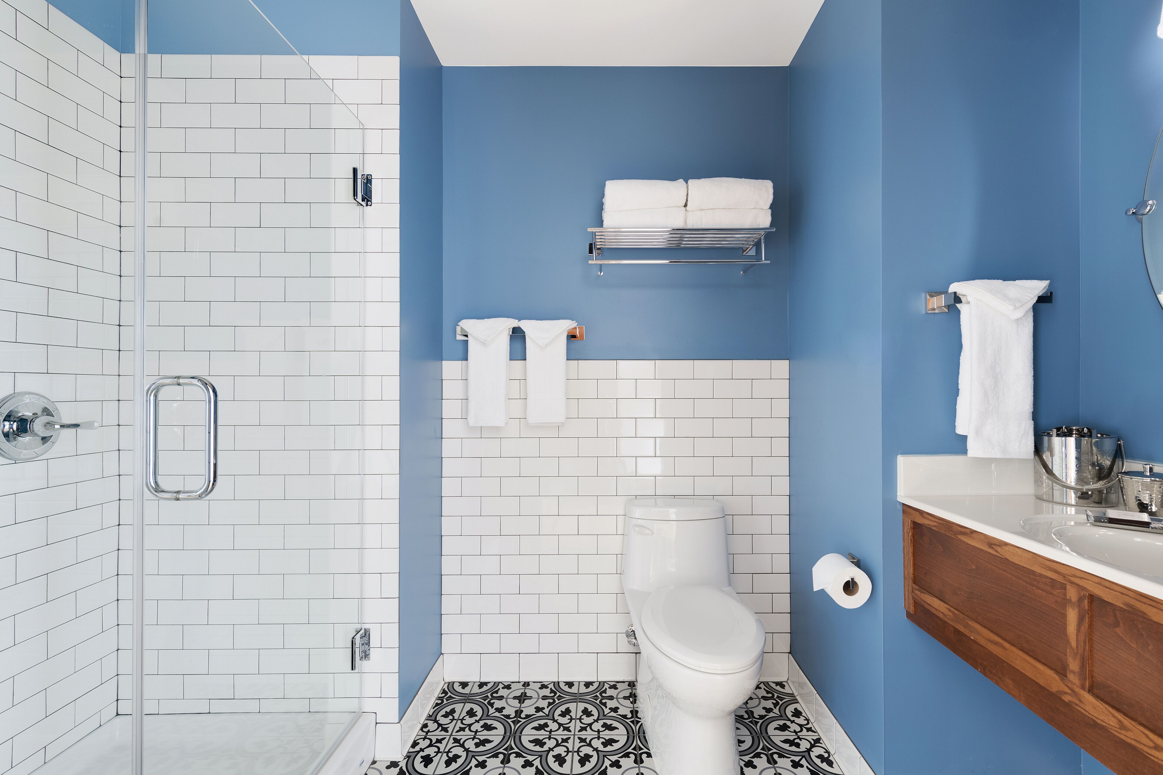 A bathroom with a shower, toilet, and sink.