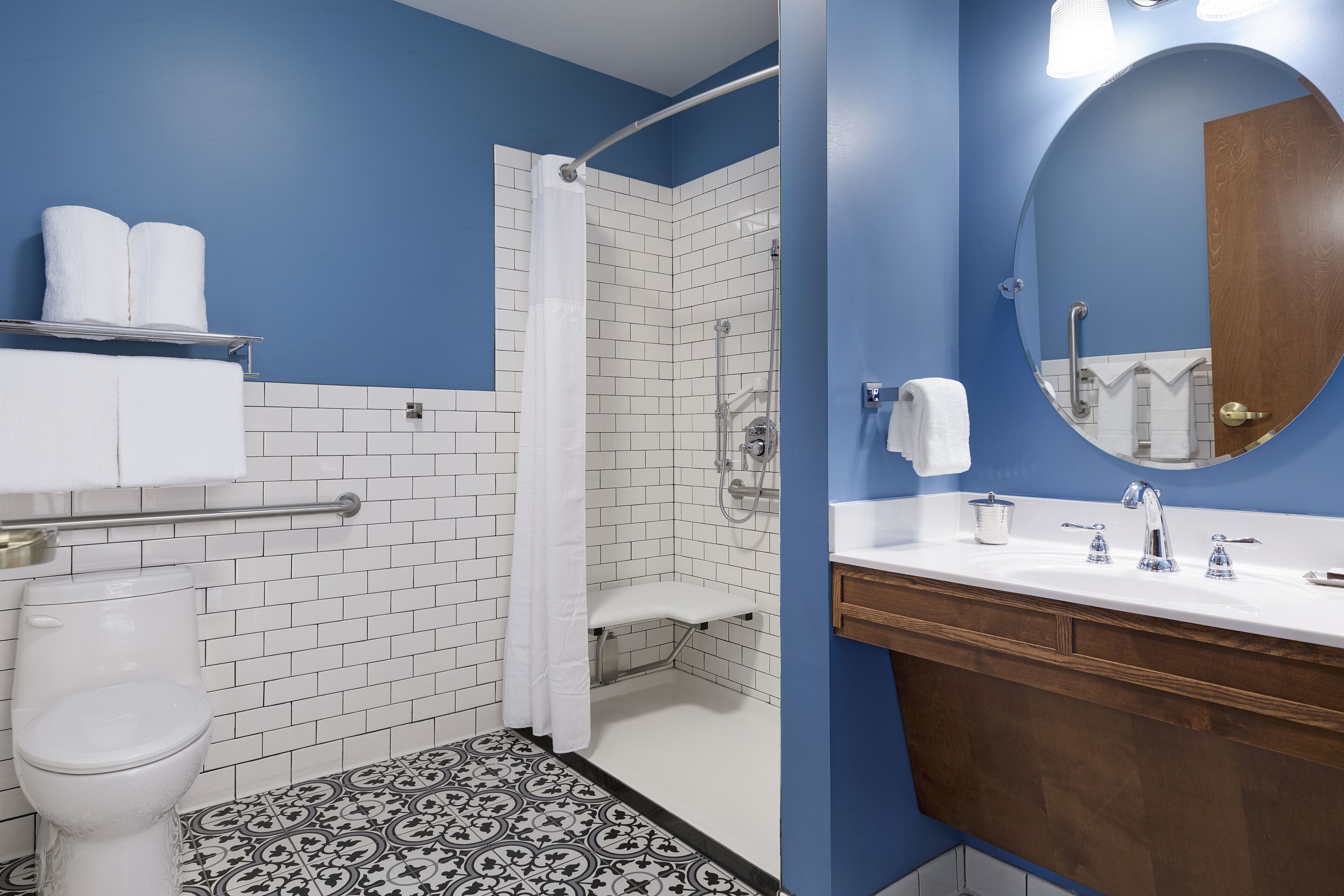 A bathroom with a shower, toilet, and sink.