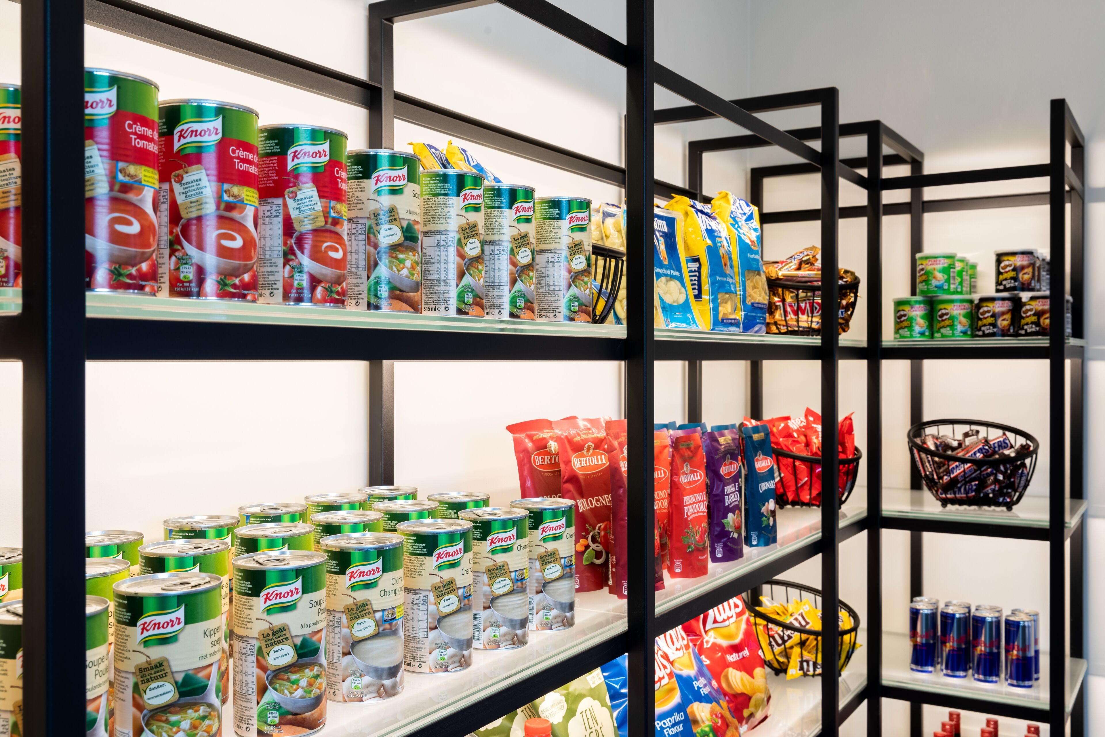 Shelves stocked with canned goods, snacks, and beverages.
