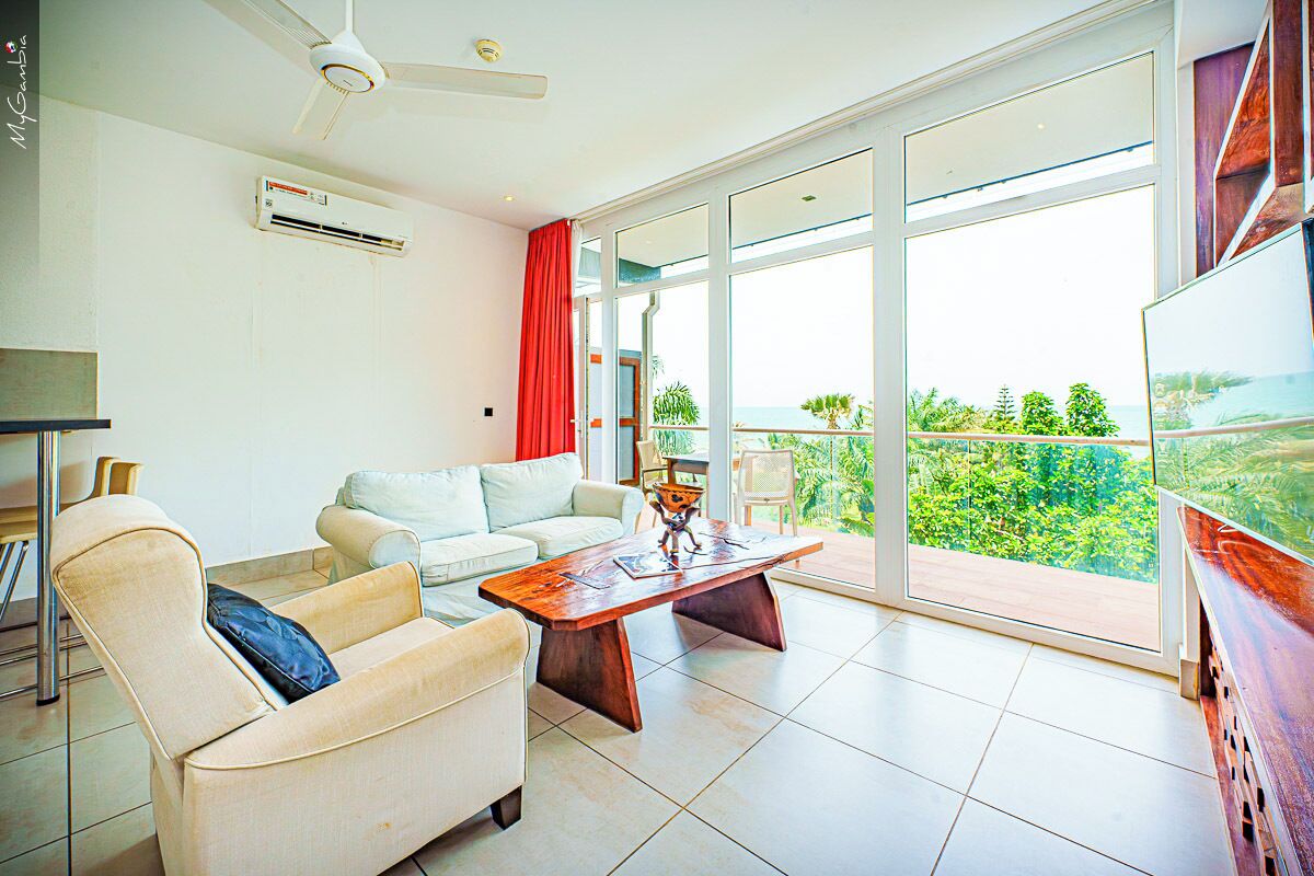 Panoramic Suite, Ocean View | Living area | TV