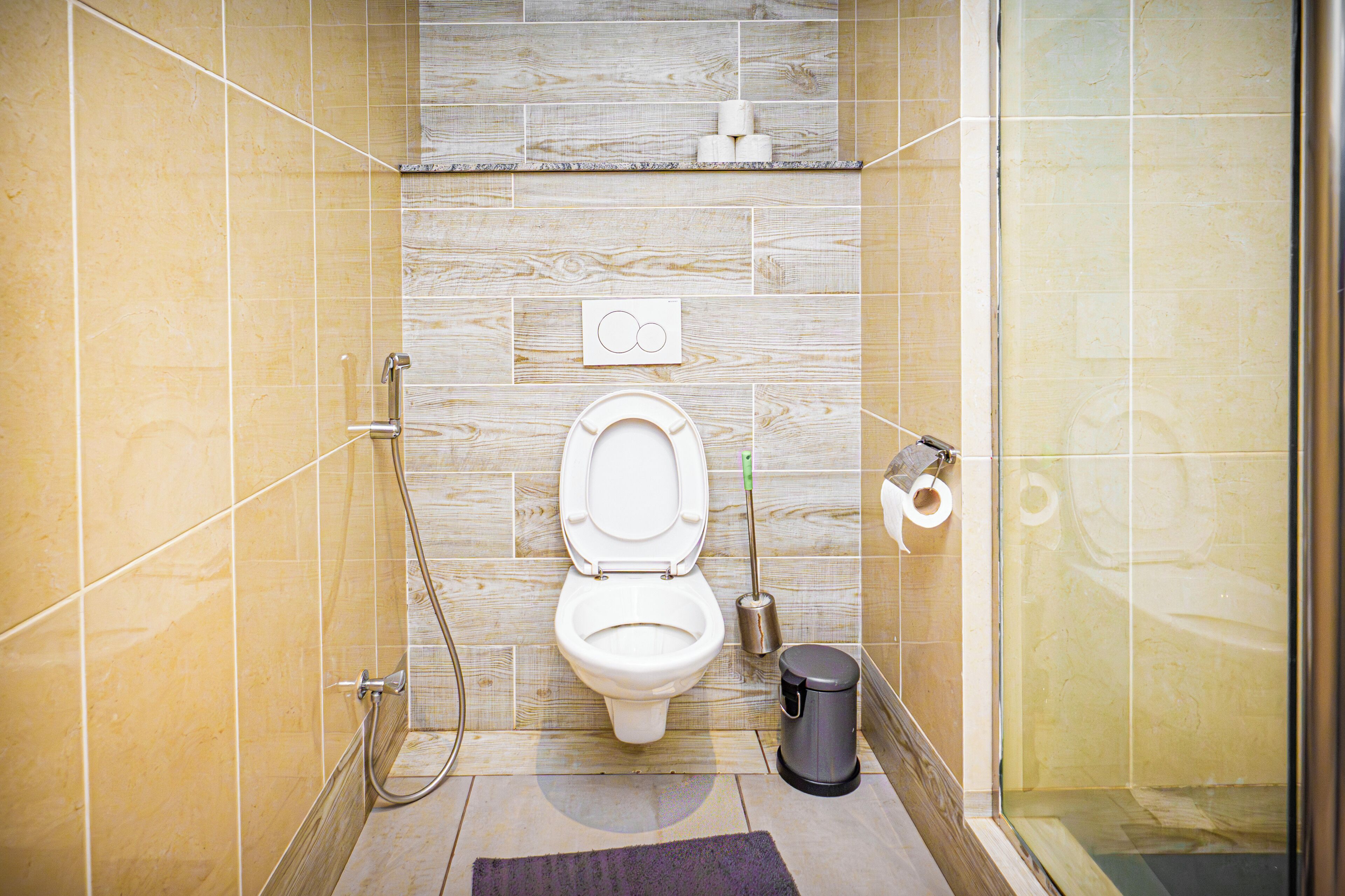 A bathroom with a toilet, bidet, and shower.