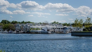 A marina with several boats docked, a waterfront building, and a clear sky. - UNION PIER HOME WITH PRIVATE HEATED POOL! (Union Pier)