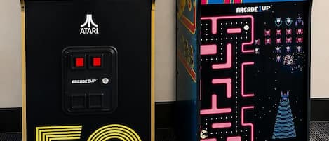 Two arcade machines, one Atari 50 and one Arcade 1UP, placed side by side.