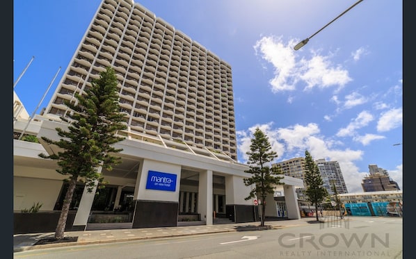 A high-rise hotel with a sign reading "Mantra on View Hotel".