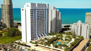 A high-rise hotel with a pool area, surrounded by other buildings and a view of the ocean. - L7 Surfers Paradise Apartment (Surfers Paradise)