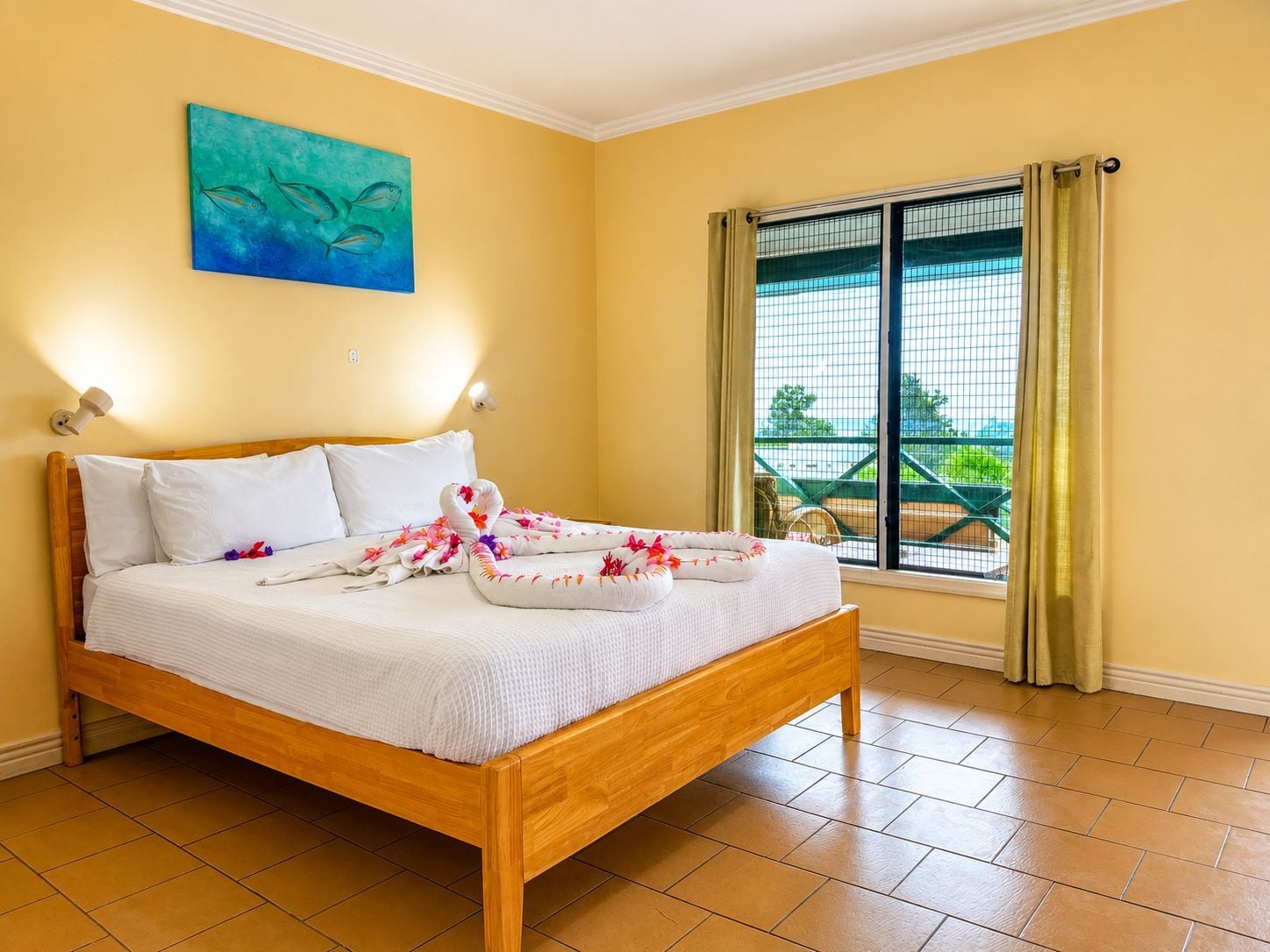 A hotel room with a wooden bed, a painting on the wall, a window with curtains, and a balcony view.