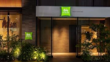 A building with signage for 'ibis Styles' at Tokyo Ginza East.