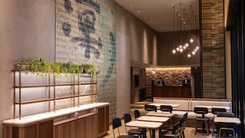 A modern interior with a reception desk, seating area, and a wall with a pattern.