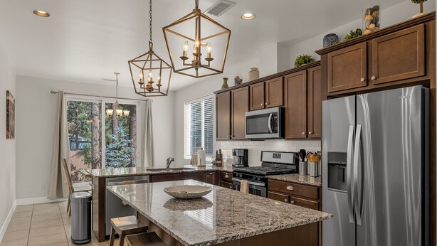 A modern kitchen with granite countertops, stainless steel appliances, and wooden cabinets. - Beautiful home! Central AC! 5 mins to Downtown! Great setting! 20% Monthly Disc! (Flagstaff)