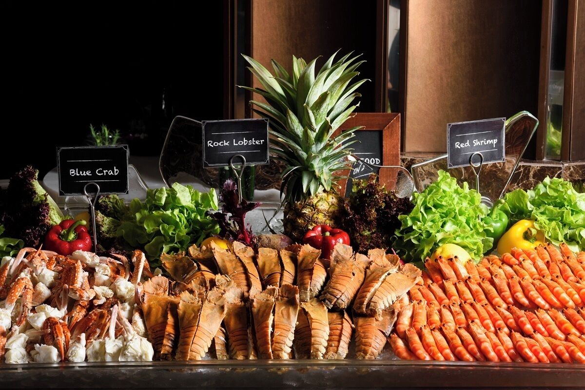 A seafood display with labels for Blue Crab, Rock Lobster, and Red Shrimp.