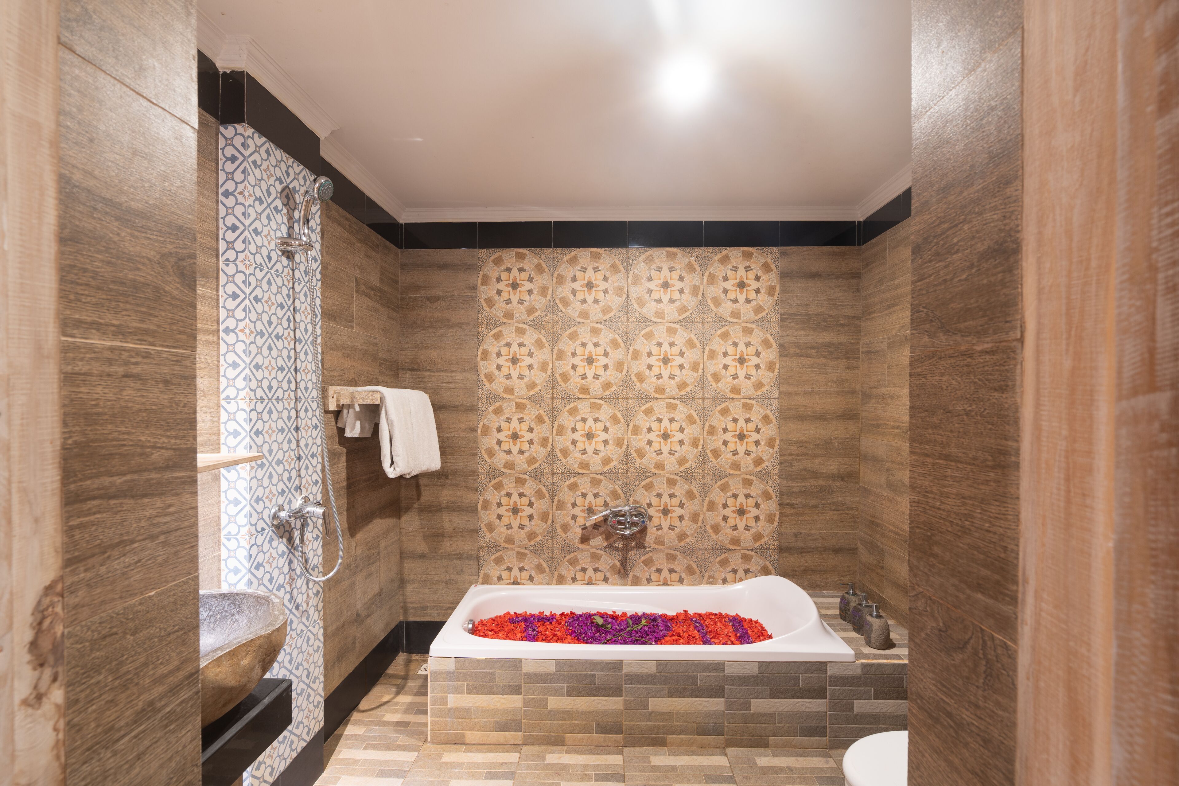 A modern bathroom with a freestanding bathtub, a built-in sink, and a shower area.