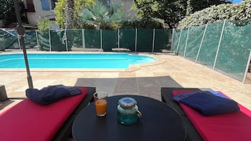 Seasonal outdoor pool, open 9:30 AM to 9:30 PM, pool loungers