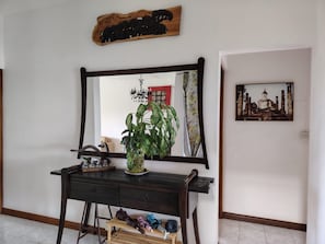 A room with a wooden dresser, a mirror, a potted plant, and a framed picture on the wall. - Three Bedroom Apartment by Dakz (Trou aux Biches)
