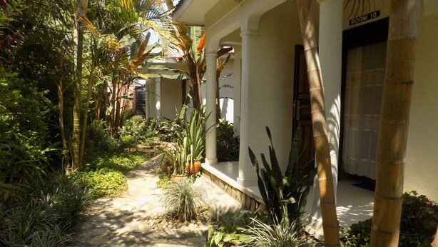 A pathway leading to a building with a sign indicating "ROOM 10". - Cielo Country Inn (Ishaka)