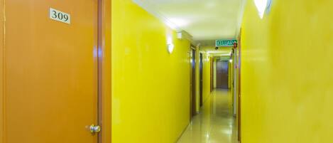 A hallway with yellow walls and a door labeled 309.