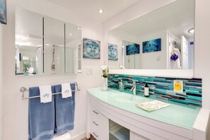 A modern bathroom with a glass sink, two mirrors, and decorative wall art. - 2 Mi to St Edward State Park: Ground-Level Studio (Kenmore)