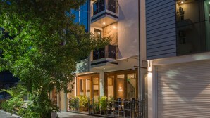 A modern building with multiple balconies, large windows, and outdoor seating. - Samann Host (Hulhumalé)