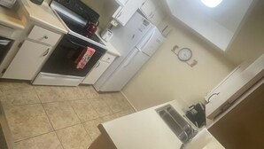 A compact kitchen with white cabinets, a built-in oven, a microwave, and a coffee maker. - Cozy Condo in Chandler, entire unit to yourself with balcony in gated community. (Chandler)