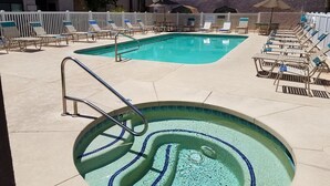A swimming pool with lounge chairs and a hot tub. - Cozy Condo in Chandler, entire unit to yourself with balcony in gated community. (Chandler)