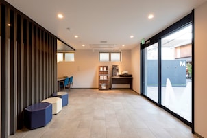 A reception area with a counter, seating, and a large window.