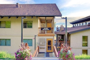 A two-story building with a balcony and a sign that reads 'STORM MEADOWS I'. - Ski In & Walk Out-Patio with Slope Views-HotTub (Steamboat Springs)