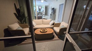 A living room with a sofa set, a coffee table, and a television.