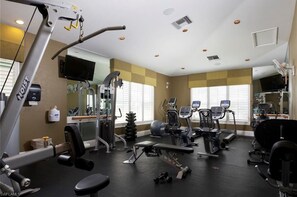 A gym with various exercise equipment, including treadmills, weight machines, and free weights. - Vacation in paradise at Lely Resort (Naples)