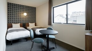 A hotel room with two beds, a round table, and a large window. - M’s Hotel Kyoto Station Kizuya (Kyoto)
