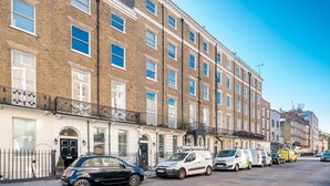 A row of terraced houses with a black car parked in front. - Upper Berkeley Street Flats (London)
