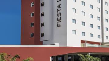 Welcome to Fiesta Inn, where a symmetrical design and lush surroundings create a serene atmosphere.
