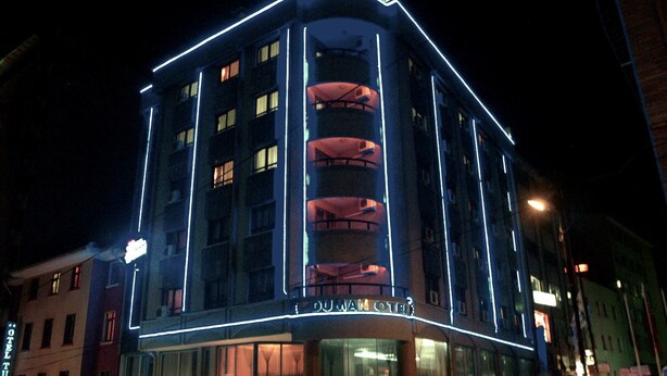 A hotel with a corner building, multiple floors, and a prominent entrance. - Grand Hotel Duman (Ankara)