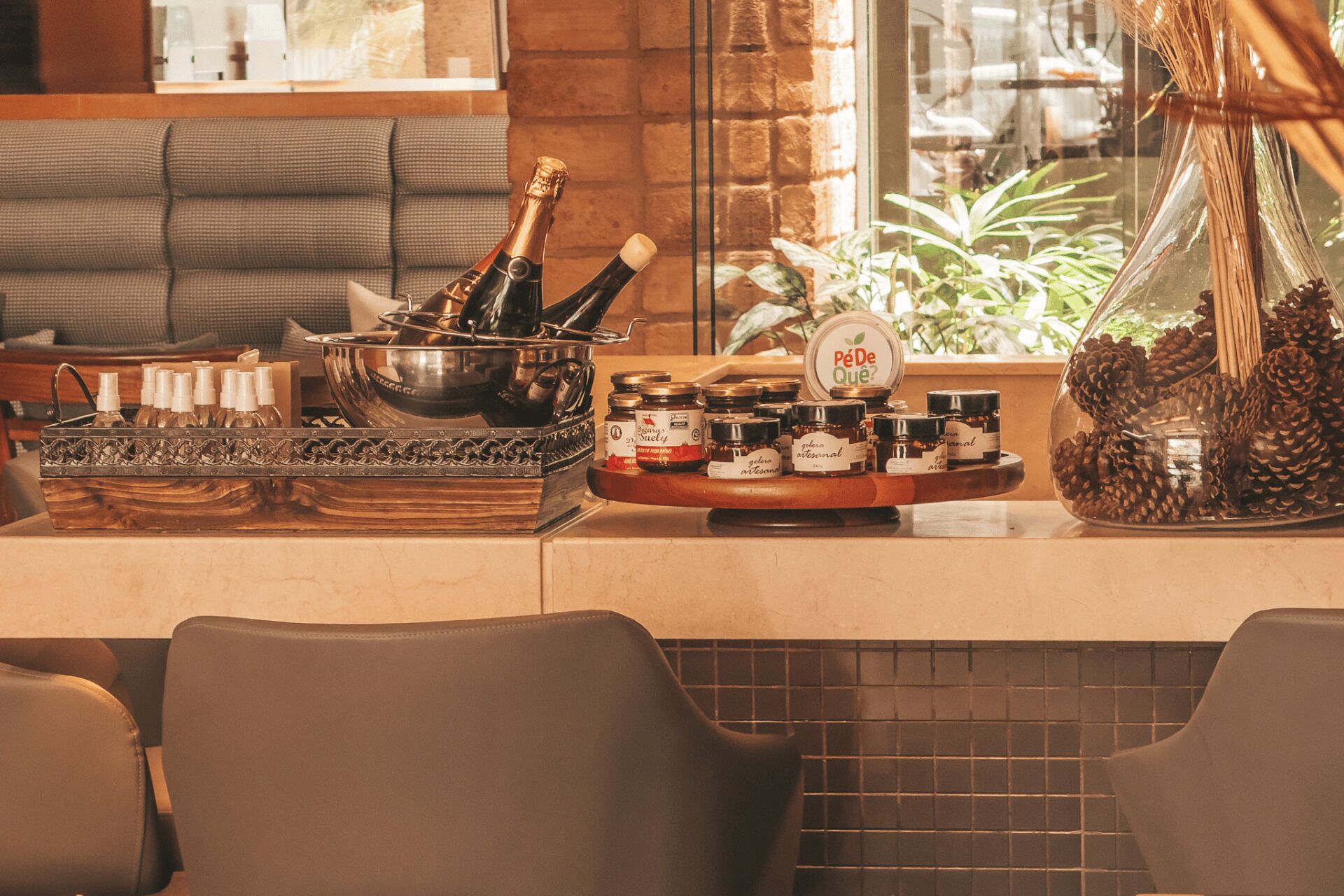 A bar area with bottles, a bowl of champagne, and jars of honey.