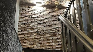 A staircase with a stone wall background and metal railings. - Hotel Frank since 1666 (Amsterdam)
