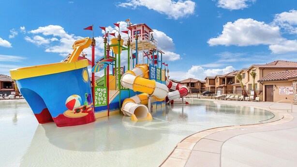 A water park with a large blue and yellow boat structure, slides, and a pool area. - Vermillion Oasis: Luxury 6BR/7BA Home near Zion. Private Pool & Resort Amenities (Santa Clara)
