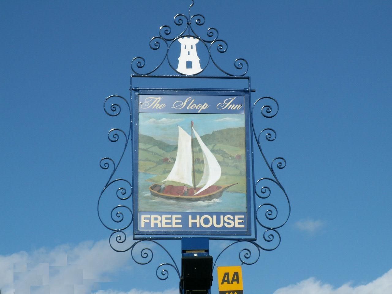 A sign for The Sloop Inn, indicating it is a free house.