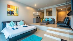 A modern bedroom with a bed, bedside tables, a sofa, and a chair. - The Ark By Veloche Group (Karon)