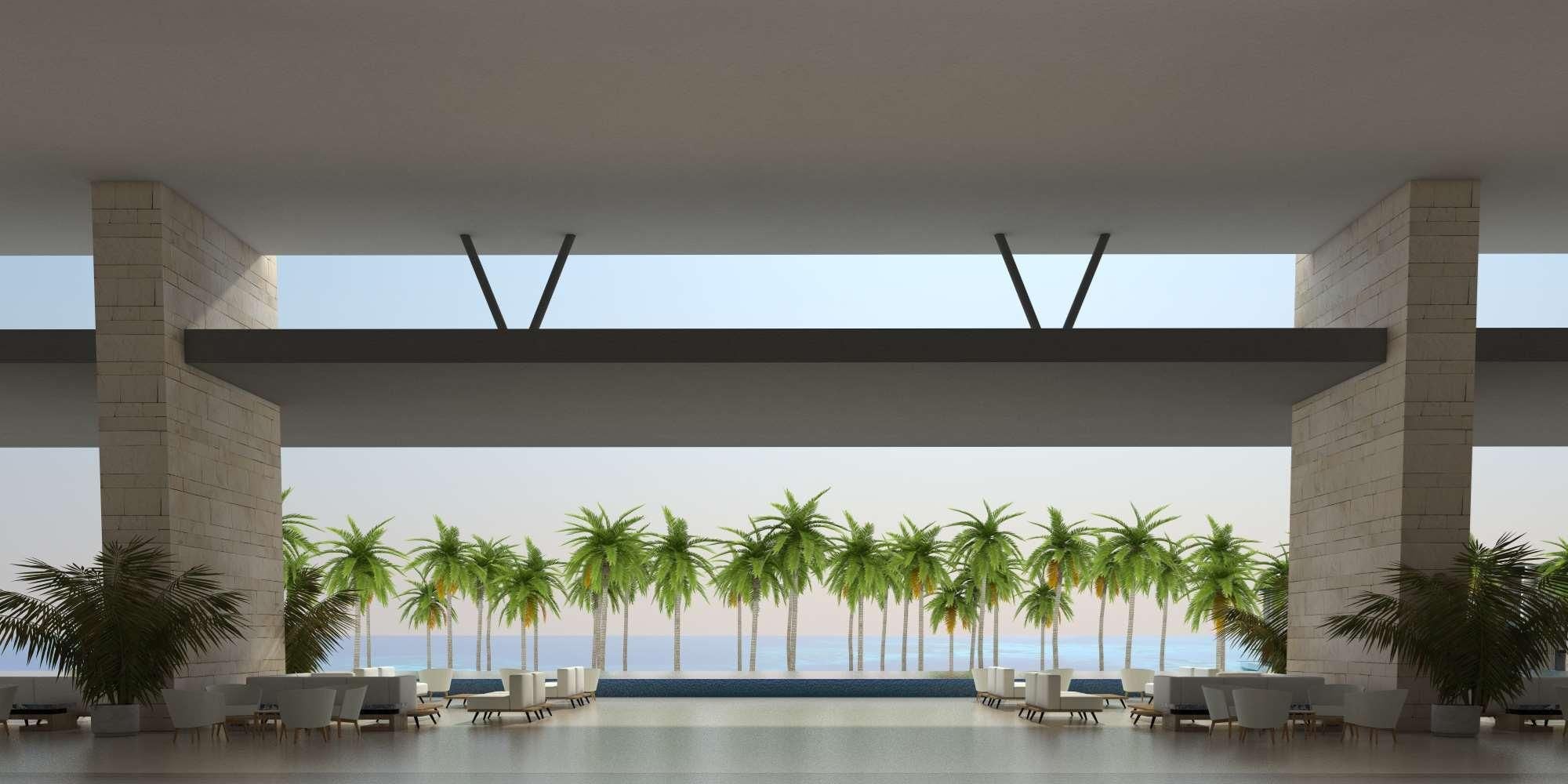A spacious indoor area with a view of palm trees and the ocean.