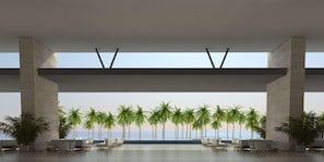 A spacious indoor area with a view of palm trees and the ocean. - Barcelo Maya Riviera (Xpu-Ha)