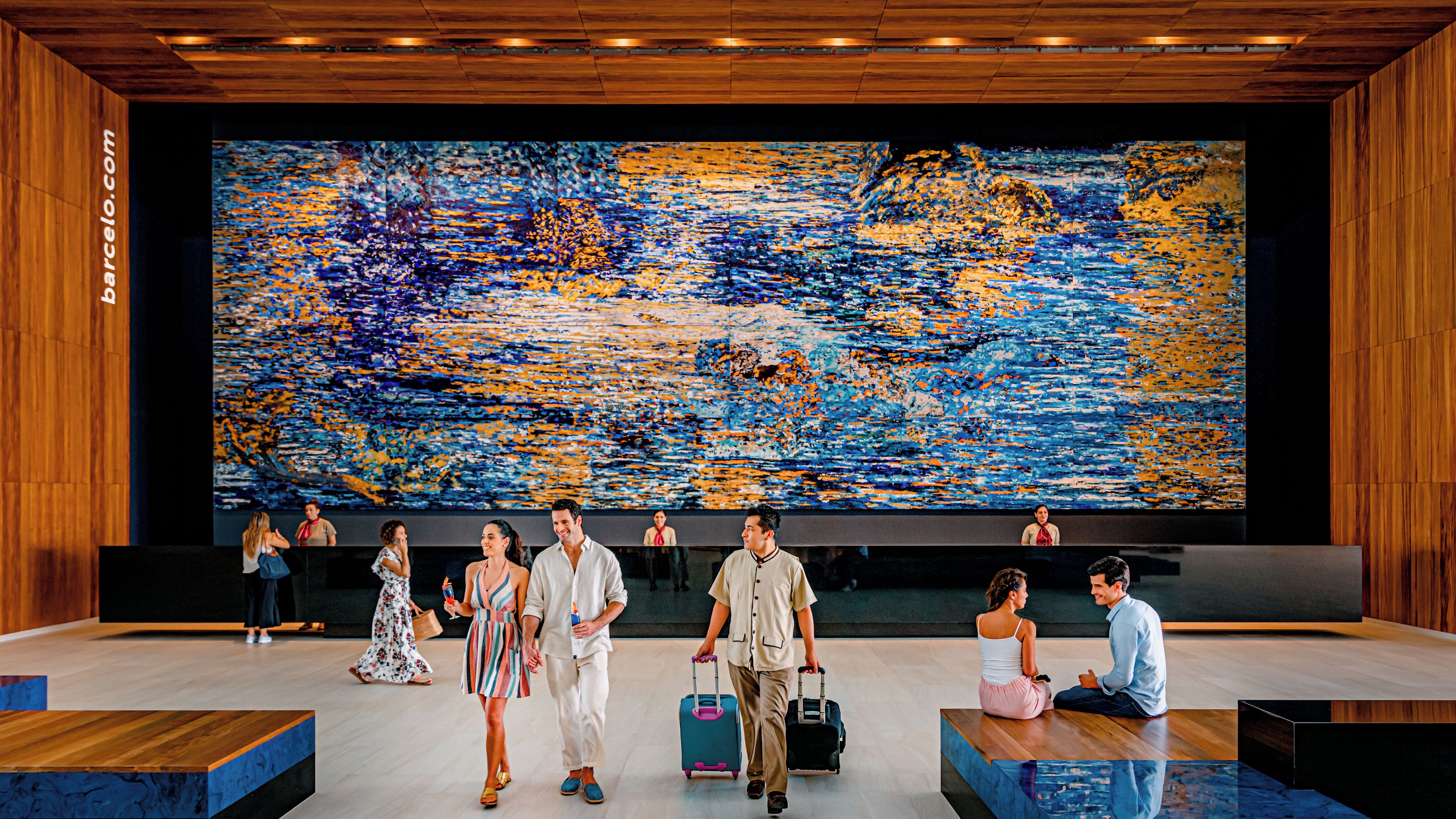 A modern lobby with a large abstract painting, wooden paneling, and a seating area.