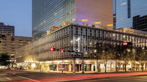 A modern hotel with a prominent glass facade, a flat roof, and a ground-level entrance with a covered walkway. - The Westin Houston Medical Center/Museum District (Houston)