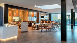 A modern hotel lobby with a bar area, seating arrangements, and a reception desk. - The Westin Houston Medical Center/Museum District (Houston)