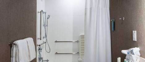 A modern bathroom with a shower, a bathtub, and a toilet.