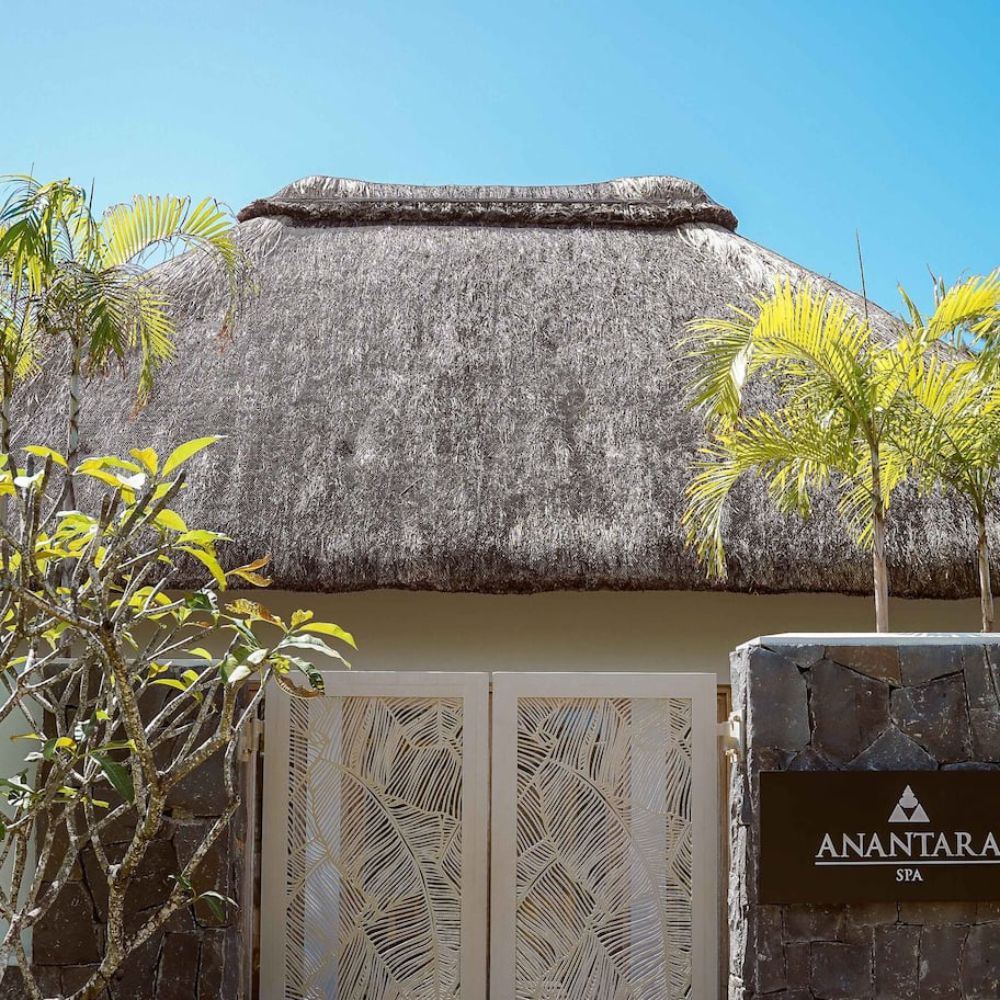 A thatched-roof building with a sign reading "ANANTARA SPA".