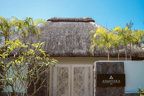 A thatched-roof building with a sign reading "ANANTARA SPA".